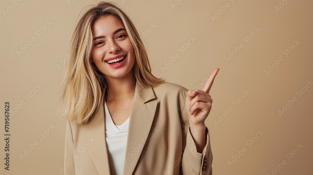 A dark blond female, against a beige background, is pointing with her index finger to the side. It's a banner featuring the girl pointing to a product for a website or advertisement. A dark blond female, against a beige background, is pointing with her index finger to the side. It's a banner featuring the girl pointing to a product for a website or advertisement.