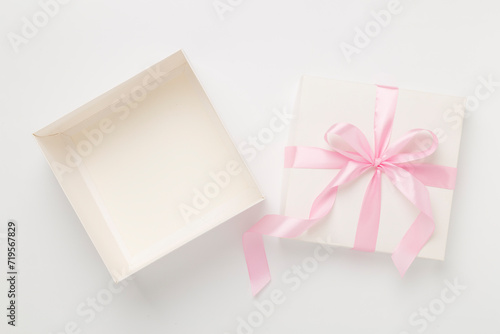 White open gift box on color background, top view. Mock up for design