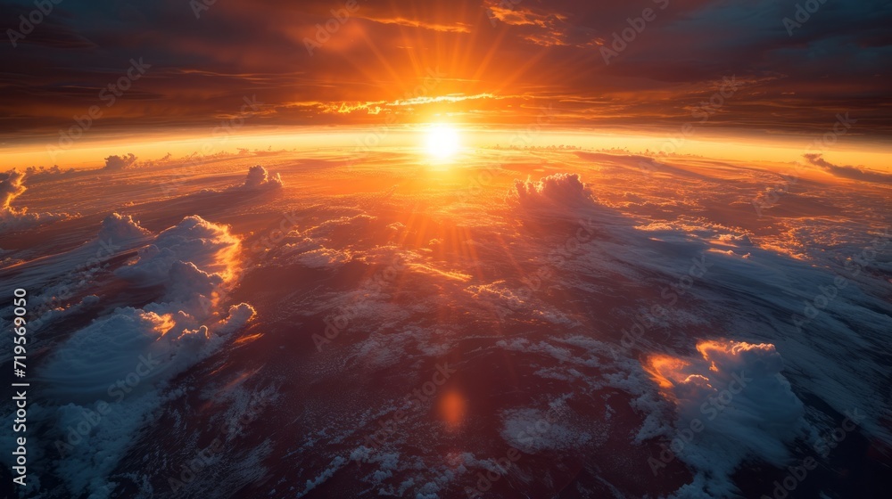 Obraz premium The sun setting behind the horizon of planet Earth, view from space