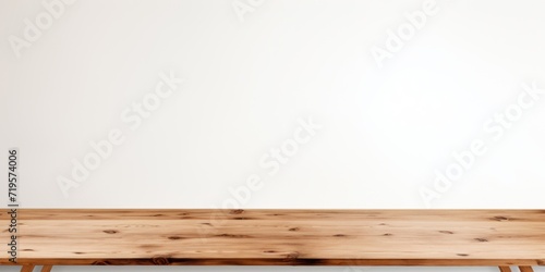 Empty wooden bronze table over white wall background