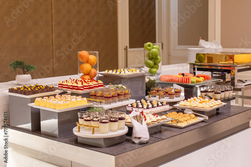 Buffet of Delicious Sweet Desserts on the Table. Arab Sweets, Mixed Fruits, and Cakes.
