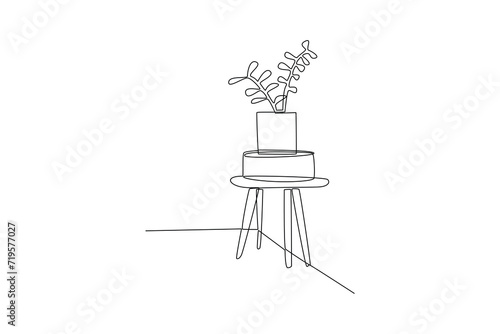 Single continuous line drawing of mini table and flower vase. Luxurious interior. interior decoration minimalist concept. Bedroom. Very cozy rooms. Staycation. One line design vector illustration