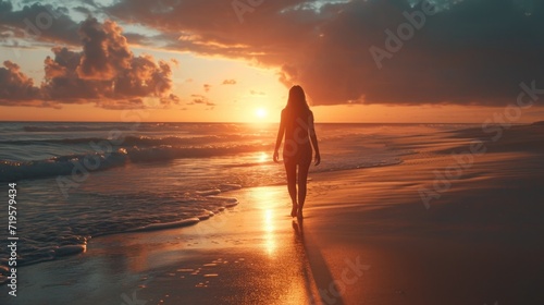 She walks on the beach sunset
