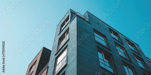 Exterior of an apartment building with open balconies. Modern multi-storey building, residential complex, creative shot.
