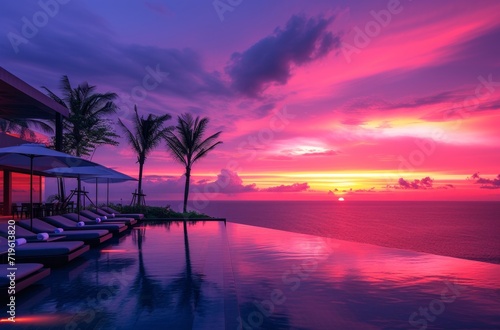 a resort pool at sunset with lounge chairs