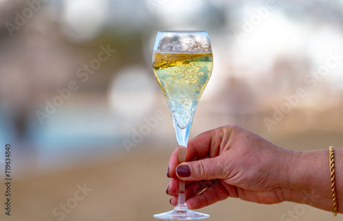 Pouring a glass of champagne on vacation, south of Fuerteventura, Canary islands, blue ocean, mountains