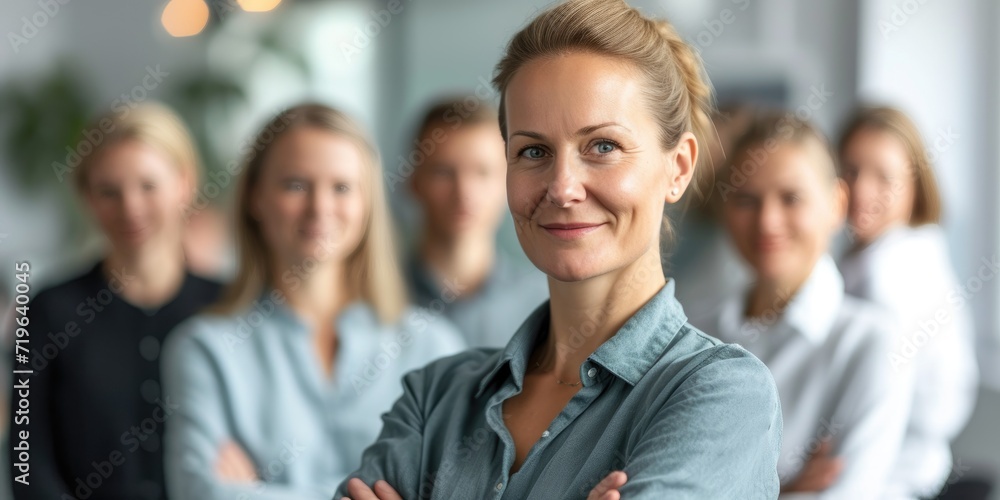 A woman leader in front of a group of employees A woman leader in front of a group of employees