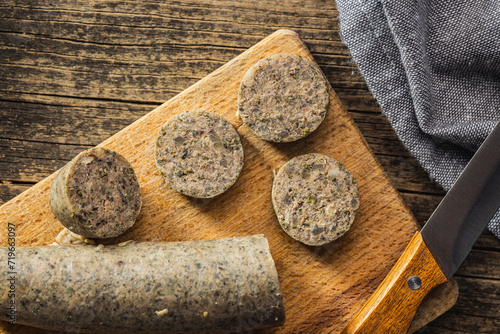 White pudding sausage. Pork product on cutting board on wooden table. Top view.