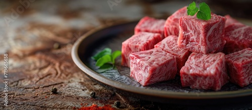 Premium Japanese wagyu diced beef cubes sliced on plate for yakiniku. Copy space image. Place for adding text photo