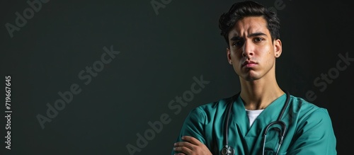 Young hispanic man wearing doctor uniform and stethoscope skeptic and nervous disapproving expression on face with crossed arms negative person. Copy space image. Place for adding text photo