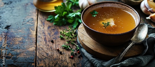 Saucepan with bouillon with a ladle on the table Bone broth. Copy space image. Place for adding text