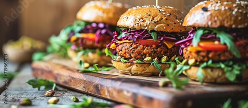Vegan burgers with lentils and pistachios stacked on a cutting board. Copy space image. Place for adding text