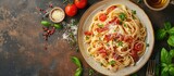 Pasta carbonara with bacon and parmesan on a plate top view. Copy space image. Place for adding text