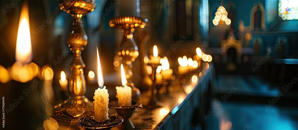 two burning candles for baptism in the orthodox church Christian faith and traditions Two burning candles in an orthodox church close up vertical orientation photo. Copy space image - obrazy, fototapety, plakaty 