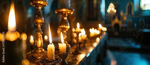 two burning candles for baptism in the orthodox church Christian faith and traditions Two burning candles in an orthodox church close up vertical orientation photo. Copy space image photo