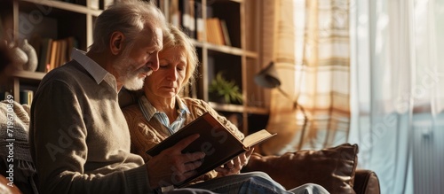 Reading book hands or old couple with bible in home for faith religion or God with hope in house Studying Jesus Christ worship or senior Christian people learning literature or spiritual prayer photo