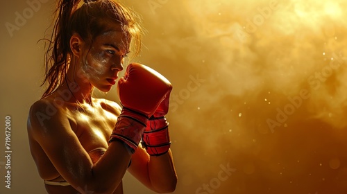 Female boxer with a determined stare, red boxing gloves on. With copy space. Concept of boxing, strength, female empowerment in sports, and athletic focus. © Jafree