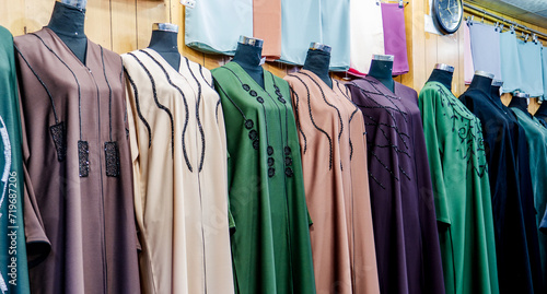 arabic women dress abaya for sale at a textile store in the souq faleh. photo
