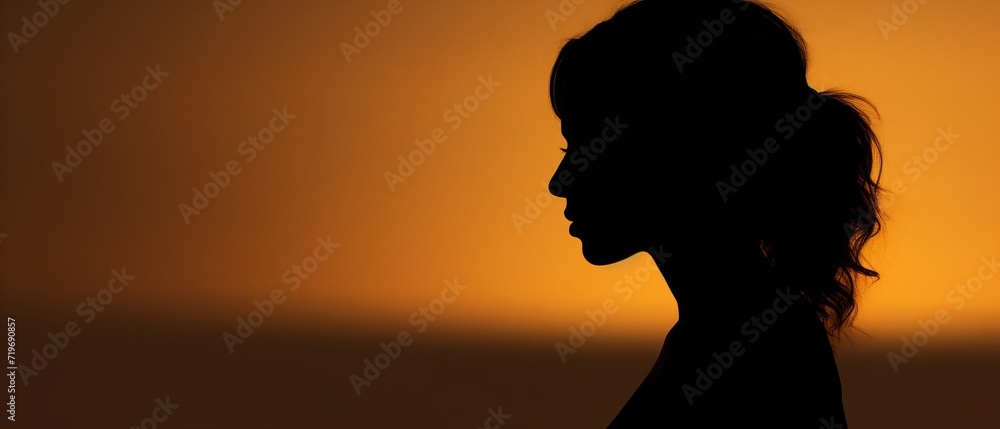 Silhouette of a girl against a sunset background
