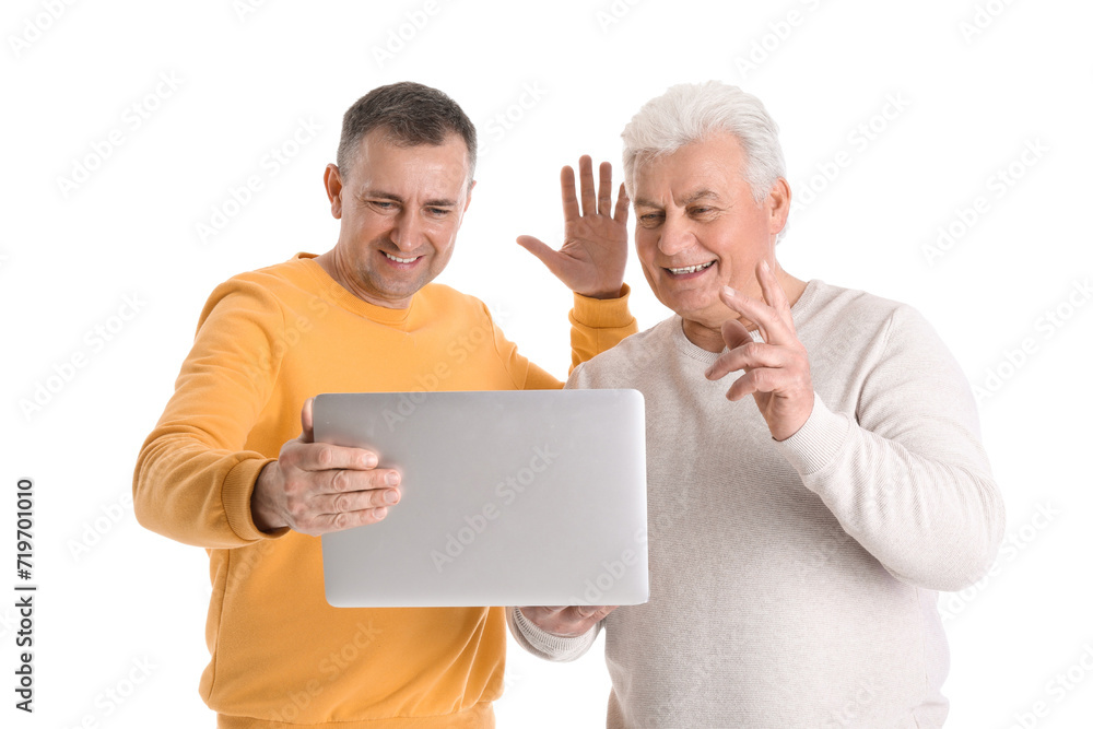 Mature brothers with laptop video chatting on white background Mature brothers with laptop video chatting on white background