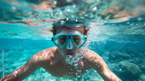 Young man snorkeling in clear tropical turqoise waters © Nikodem