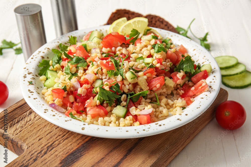 Plate with delicious tabbouleh salad on table, closeup Plate with delicious tabbouleh salad on table, closeup
