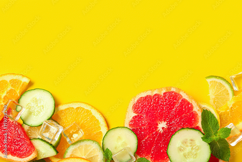 Composition with ice cubes and fresh ingredients for lemonade on yellow background