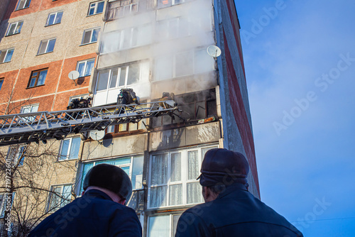 Firefighters extinguish a fire while climbing the stairs, risking their lives in danger in a multi-story building