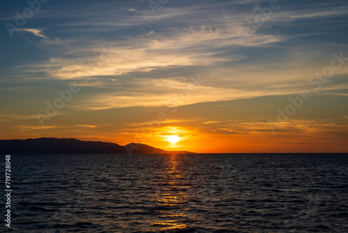 Obraz na płótnie Sunset at Aegean sea at Zakynthos island in Greece. Sun setting behind the mountain w salonie