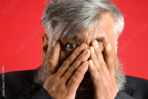 Afraid mature man on red ba...