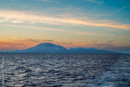 Zakynthos, Greece - May -31 -2019 : Wide angle of a mountains and sea waves during golden hour on a sea