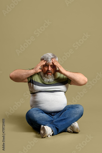 Afraid mature man sitting o...