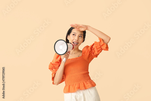 Young Asian woman with mega...