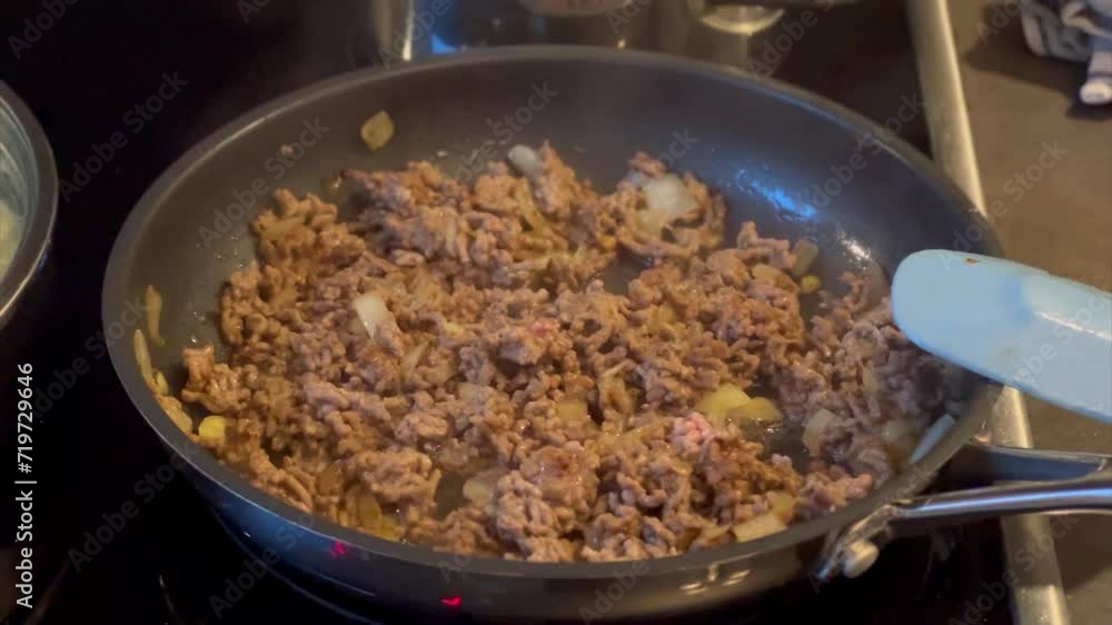 Close up of ground beef frying in a pan 