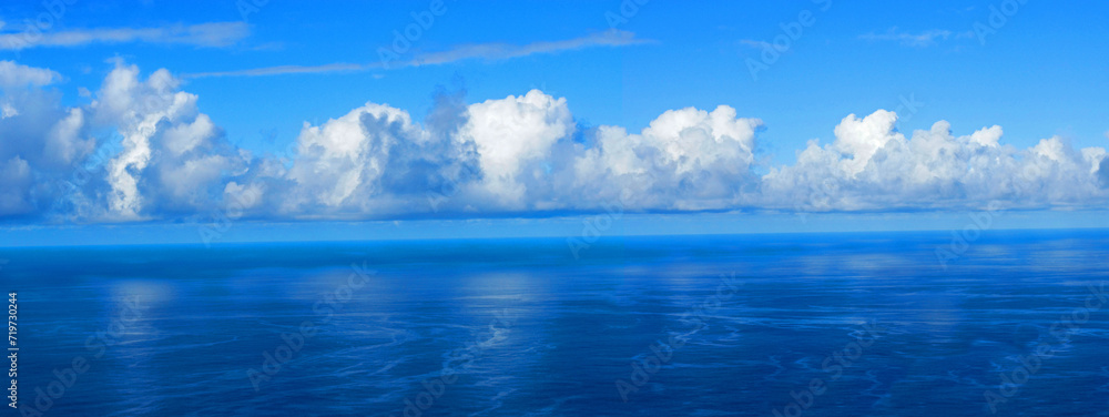 View over the blue Atlantic Ocean with white clouds, panoramic shot, from the mountain slopes near Barlovento, La Palma, Canary Islands, Spain