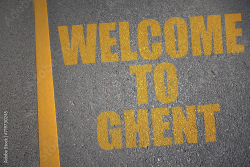 asphalt road with text welcome to Ghent near yellow line.