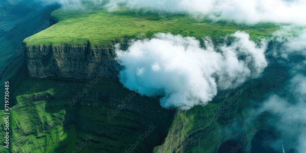 Large white cumulus cloud fell on a green breathtaking cliff, drone view
