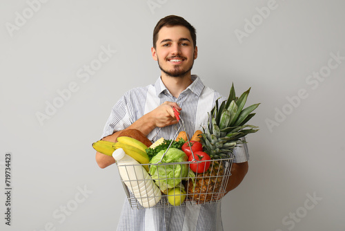 Young man with shopping bas...