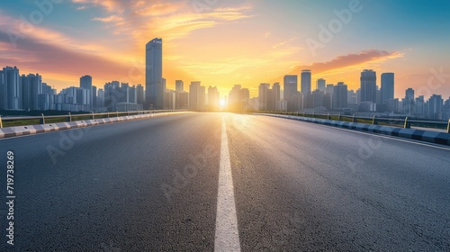 Empty asphalt road and modern city skyline with building scenery at sunset. high angle view.