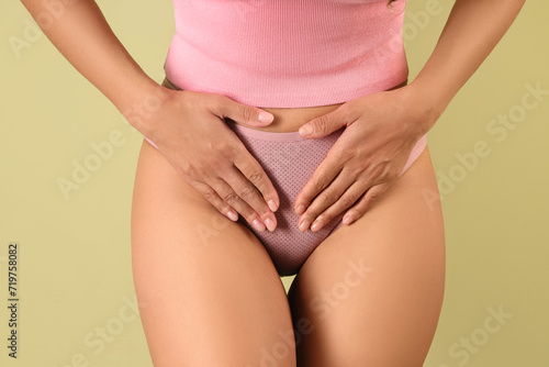 Wallpaper Mural Young woman in pink menstrual panties on green background, closeup Torontodigital.ca