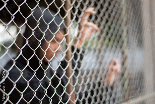 Photos Detention of preteens inside the metal fence and wall because of their bad behavior and habits, freedom and human rights concept
