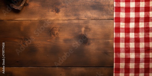 Wooden board on tablecloth over grunge surface.