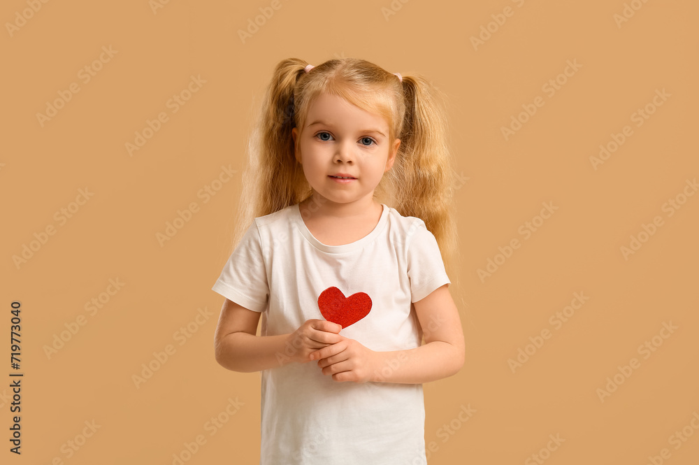 Cute little girl with heart on beige background. Valentine's Day celebration Cute little girl with heart on beige background. Valentine's Day celebration