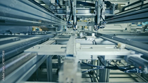 Production of solar panels. Automated equipment at work inside the modern industrial plant.
Aluminum gluing.  4k