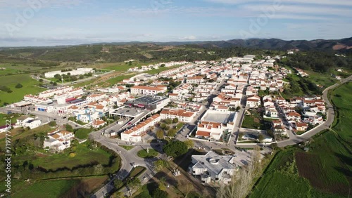 Aerial establishing shot of small town of Aljezur in Algarve countryside, Portugal, Orbit shot
