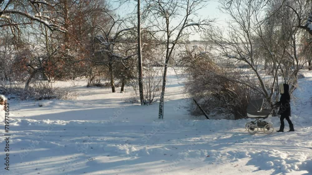 Single mother slowly walk on snowy countryside yard road, cold winter Single mother slowly walk on snowy countryside yard road, cold winter