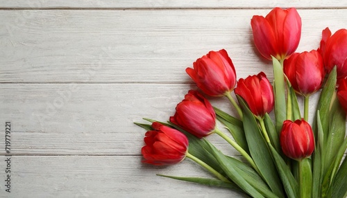 Beautiful red spring tulips on pink wooden background, flat lay. Space for text	
