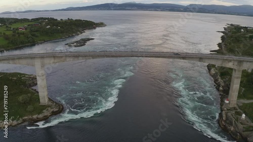 Aerial shot of Saltstraumen Bridge in Norway, showing some of the tidal currents and on the horizon you see the city of Bodo. photo