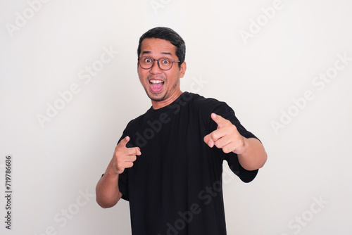 Adult Asian man pointing at the camera with excited expression photo