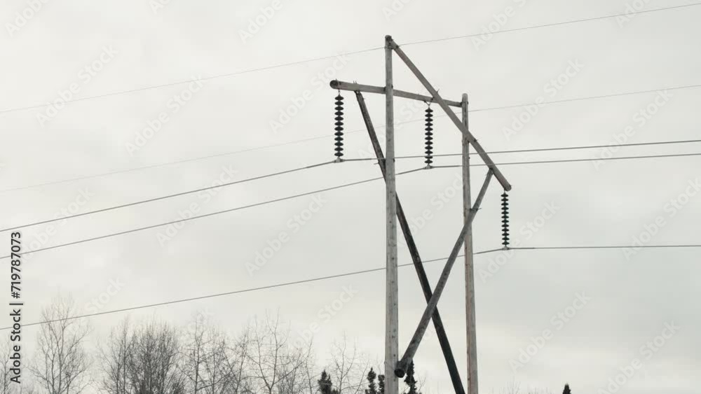 Slow Close Up Overcast Panning Shot Large Wooden Electricity Network Phone Transmission Tower Electrical Pylon Carrying High Voltage Current Long Distances Outdoor Environment Power Infrastructure